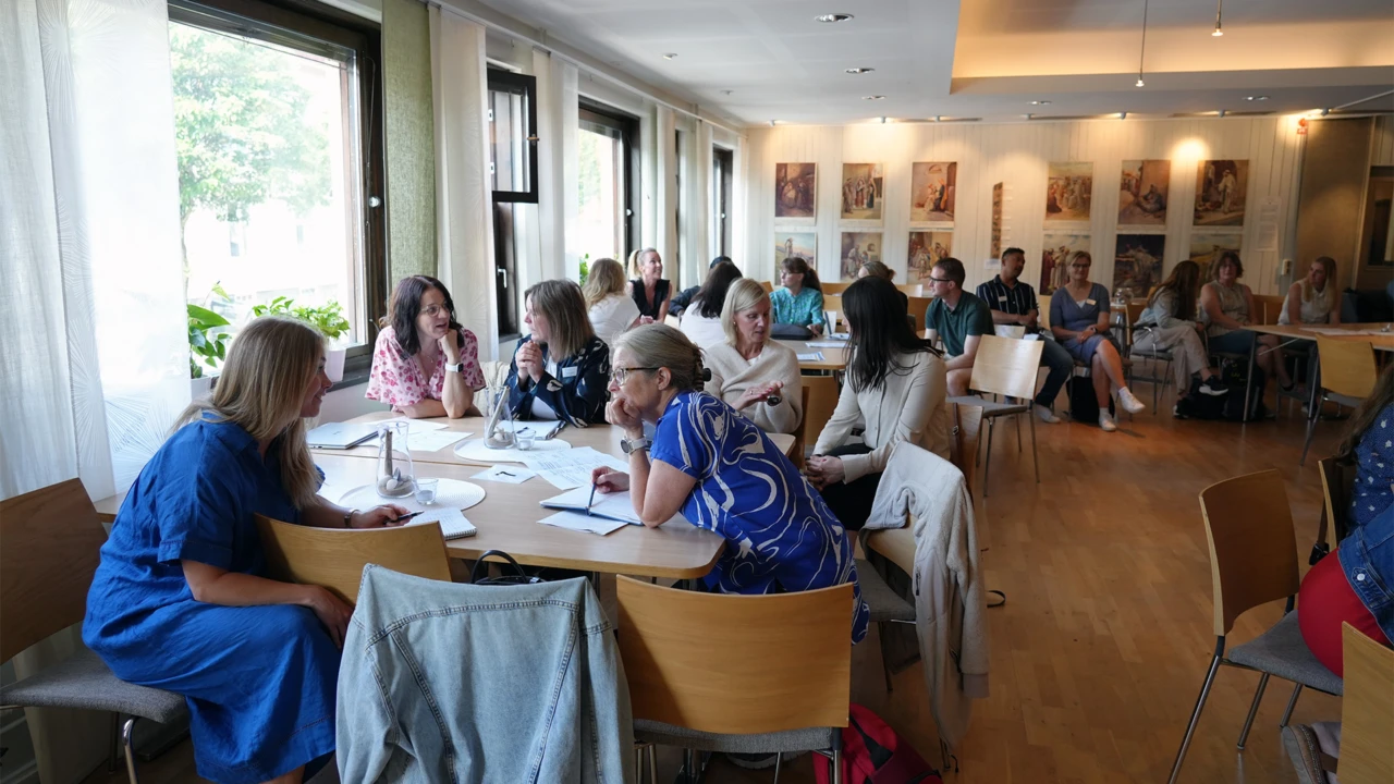 Pedagoger sitter i samtal runt bord