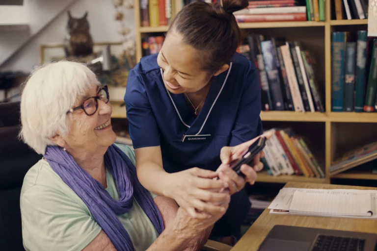 En medarbetare som hjälper en äldre person.