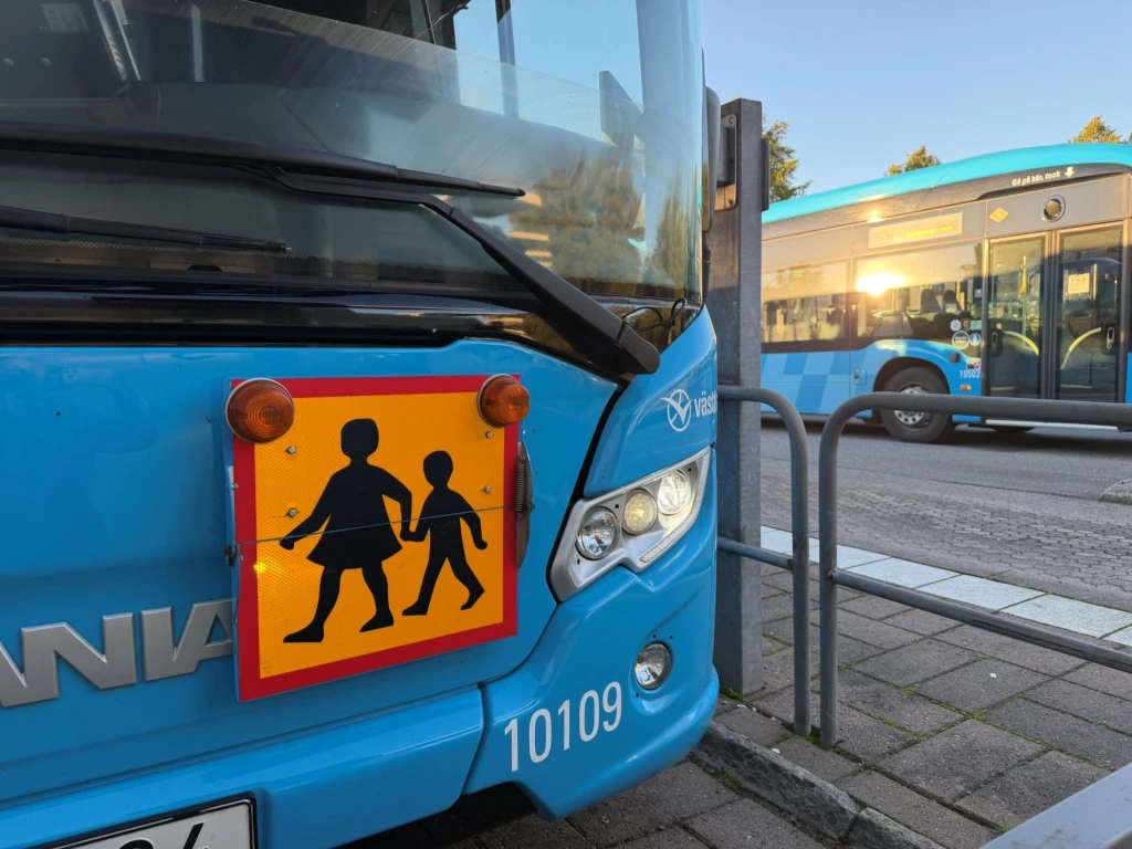 Blå buss med skylt för skolskjuts på.